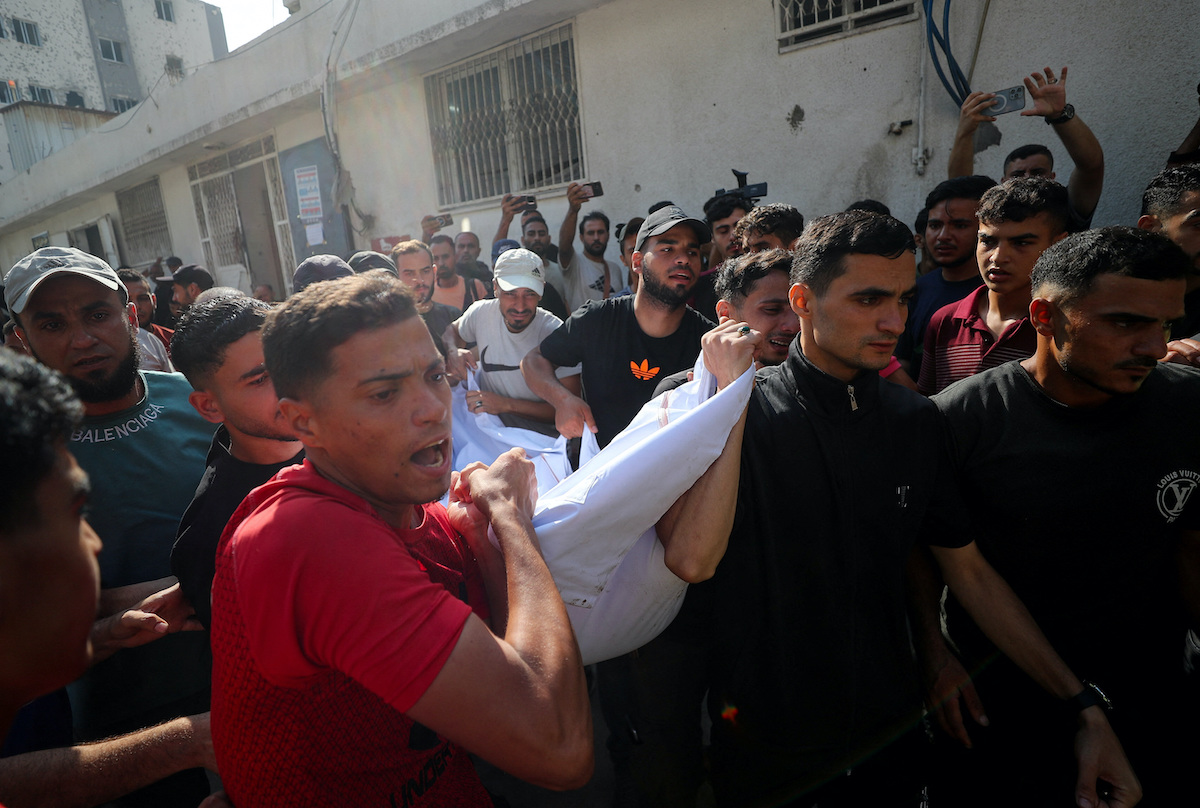 Mourners carry a body at Al-Shifa Hospital in Gaza City on Friday during the funerals of Palestinians killed in overnight Israeli strikes. (Reuters)