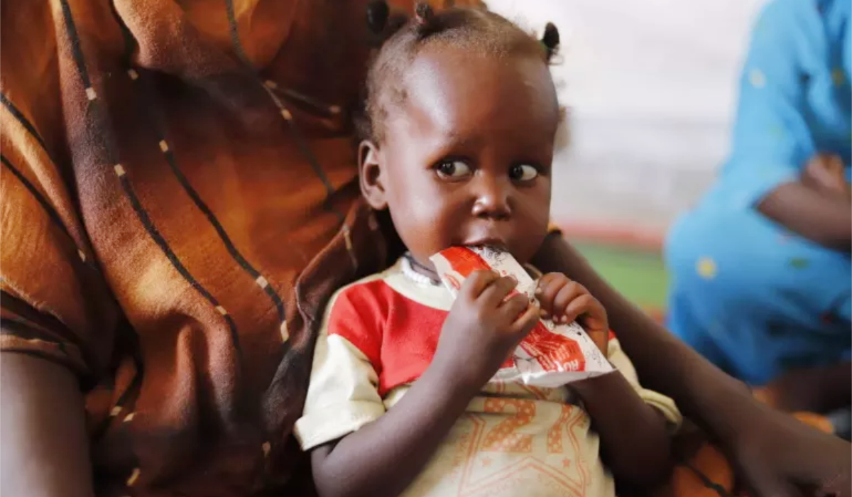 A child suffering from malnutrition eats ready-to-use food at a UNICEF-supported clinic in Tawila, North Darfur. (UNICEF)