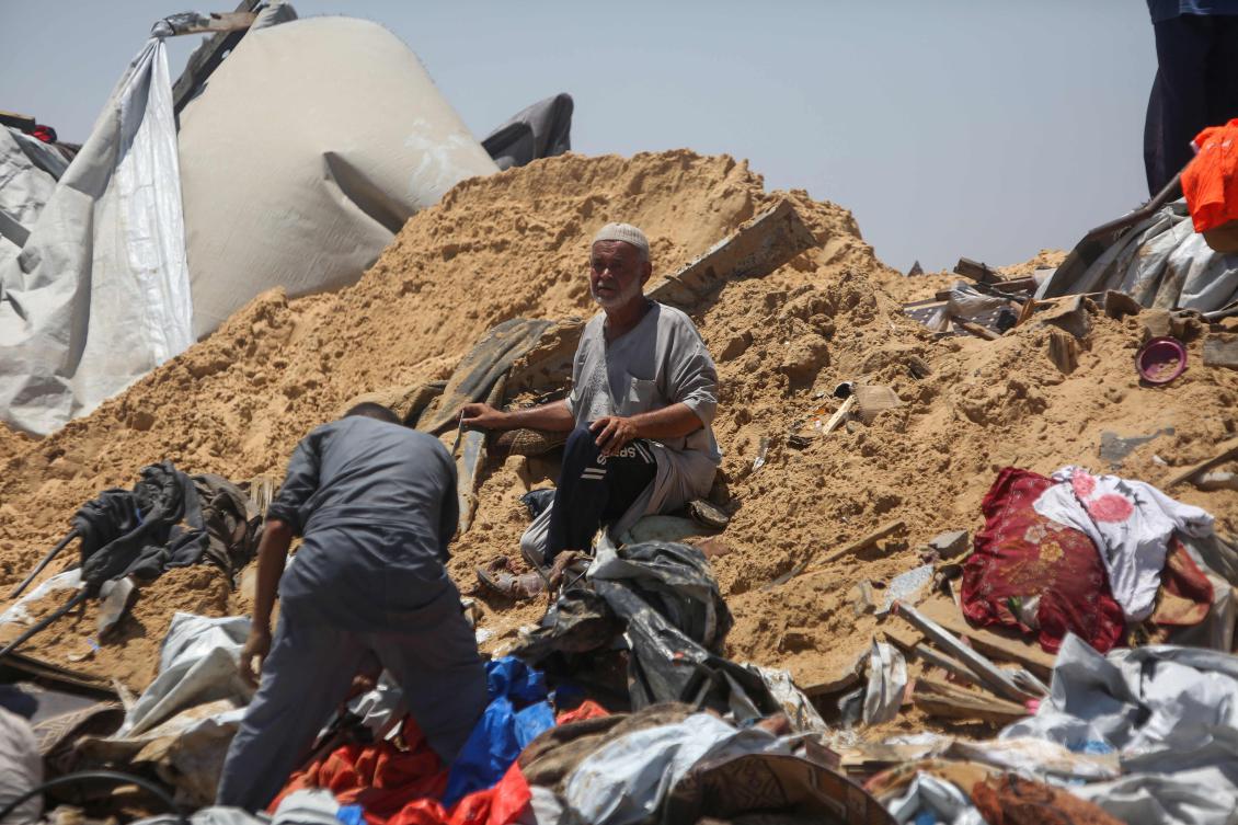 Palestinians inspect the destruction at a makeshift displacement camp following a reported incursion a day earlier by Israeli tanks in the area in Khan Younis in the southern Gaza strip on July 11, 2025. (AFP)