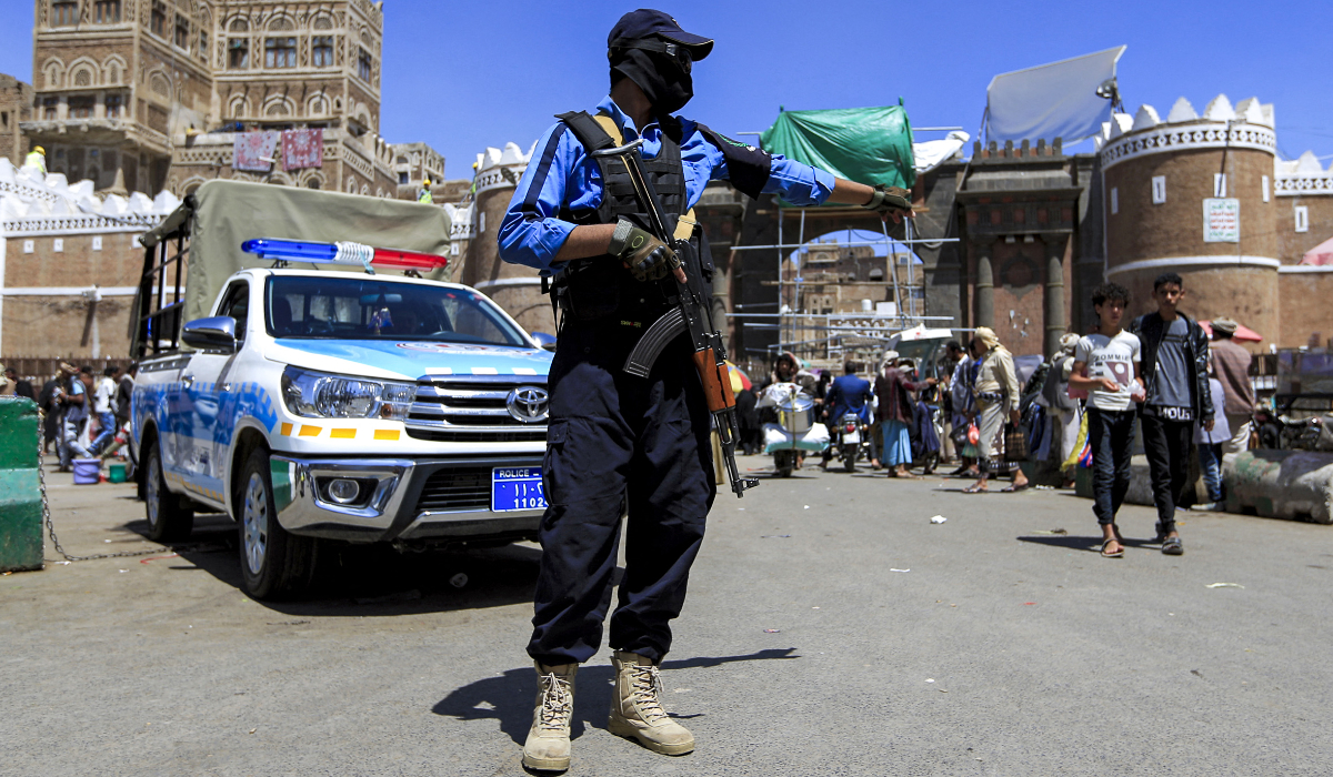 A member of the traffic police forces loyal to Yemen's Houthi rebels controls traffic along a road in the Houthi-held capital Sanaa on March 24, 2022. (AFP)