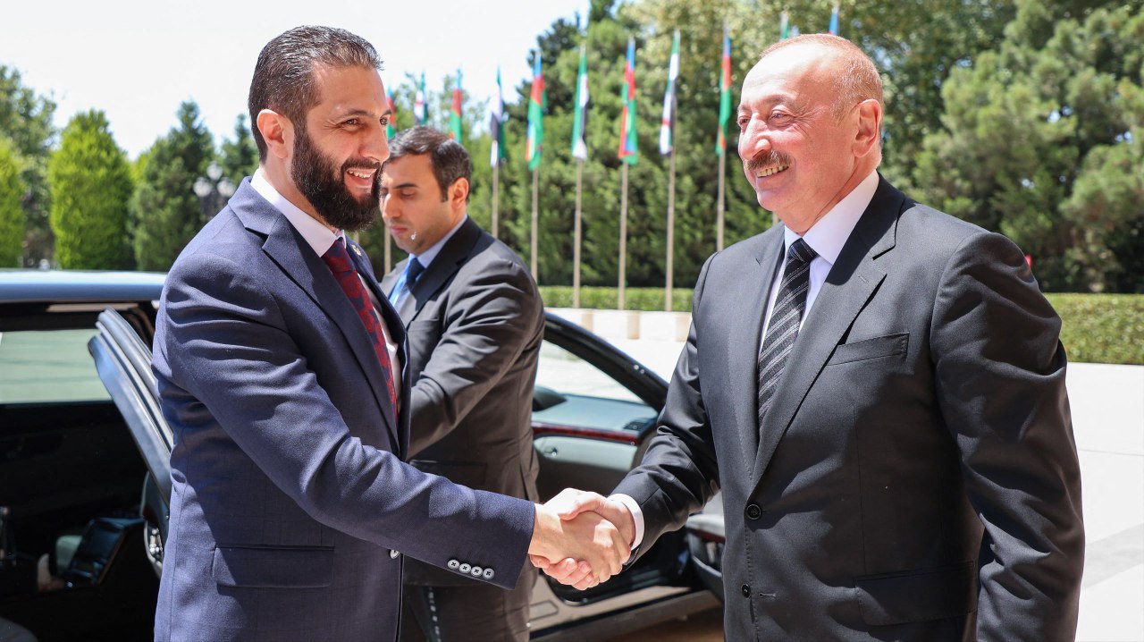 This handout picture released by the Syrian Presidency shows Azerbaijan’s President Ilham Aliyev (R) receiving Syria’s interim President Ahmed Al-Sharaa in Baku on July 12, 2025. (AFP via handout Syrian Presidency)