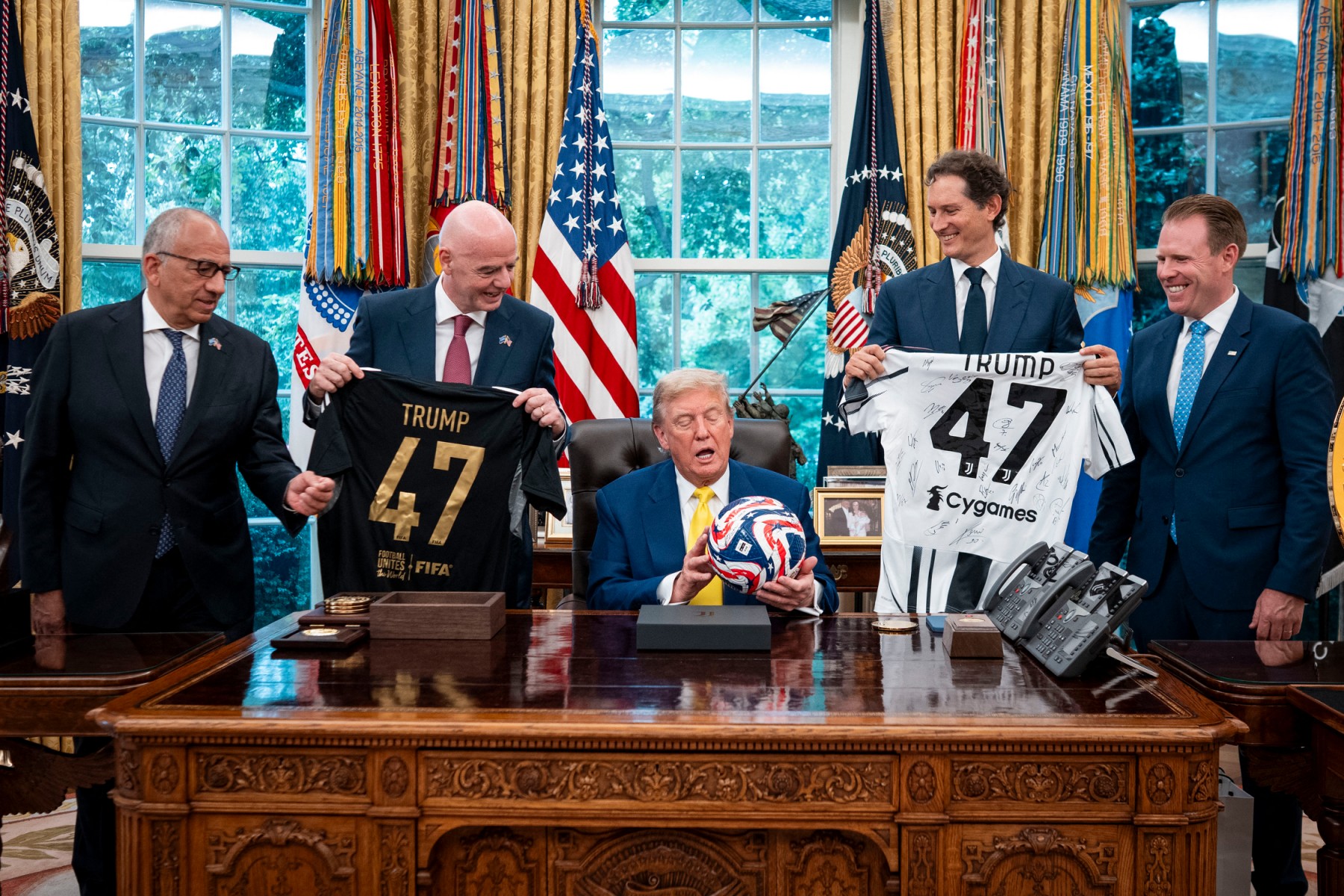 US President Donald Trump (C) flanked by (L/R) Carlos Cordeiro, former president of the United States Soccer Federation, FIFA President Gianni Infantino, Chairperson of Ferrari John Elkann and Executive Director of the presidential task force for the 2026 FIFA World Cup Andrew Giuliani, holds a ball as he makes remarks in the Oval Office of the White House during a visit by members of Italian soccer club Juventus in Washington, DC, on June 18, 2025. (AFP)