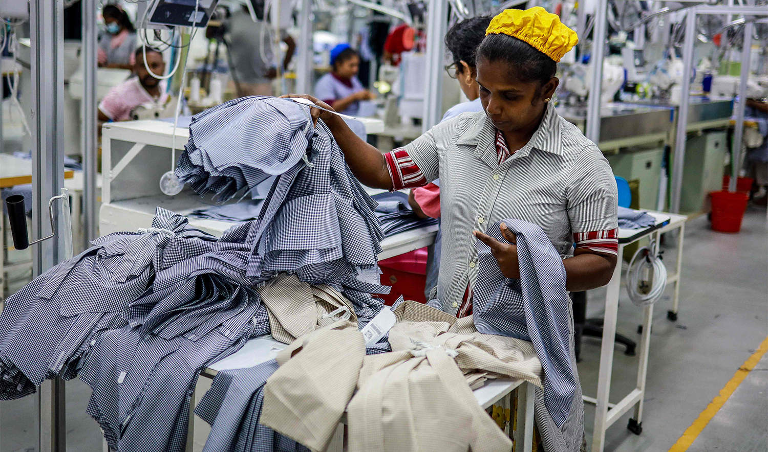 An employee checks the quality of clothes at a garment factory in Katunayake, Sri Lanka, on July 12, 2025. (REUTERS)