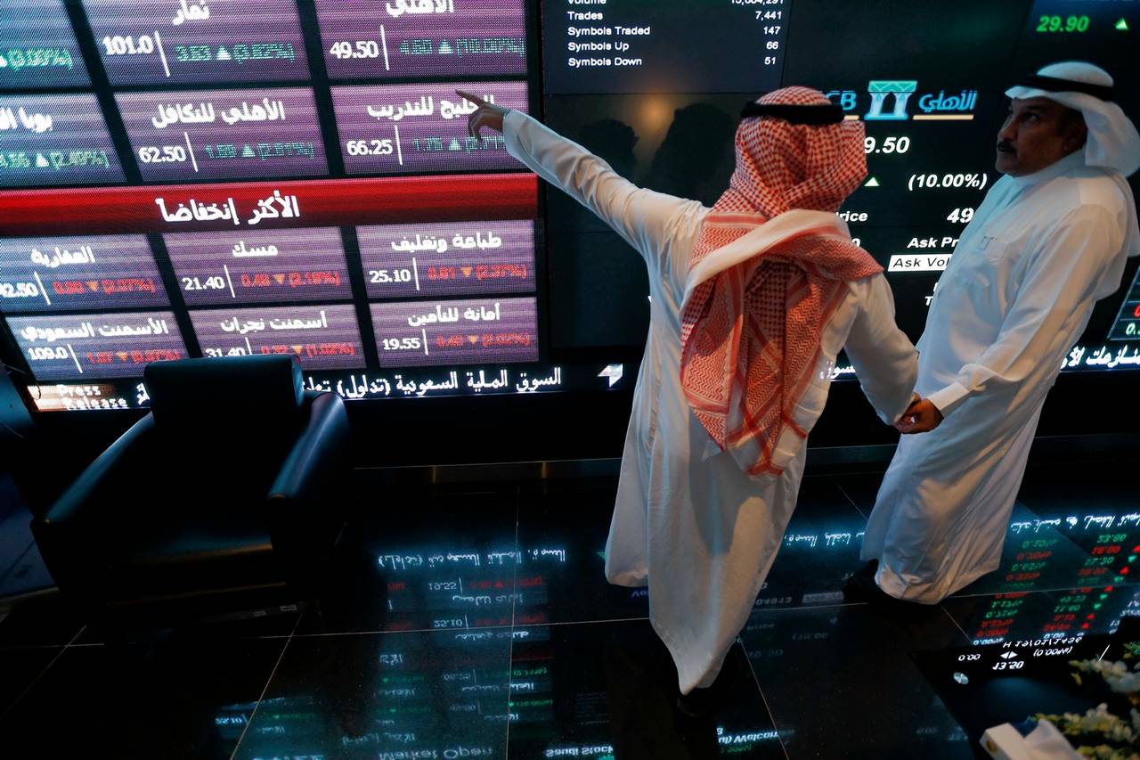 Investors monitor screens displaying stock information on the Saudi stock exchange. File/Reuters