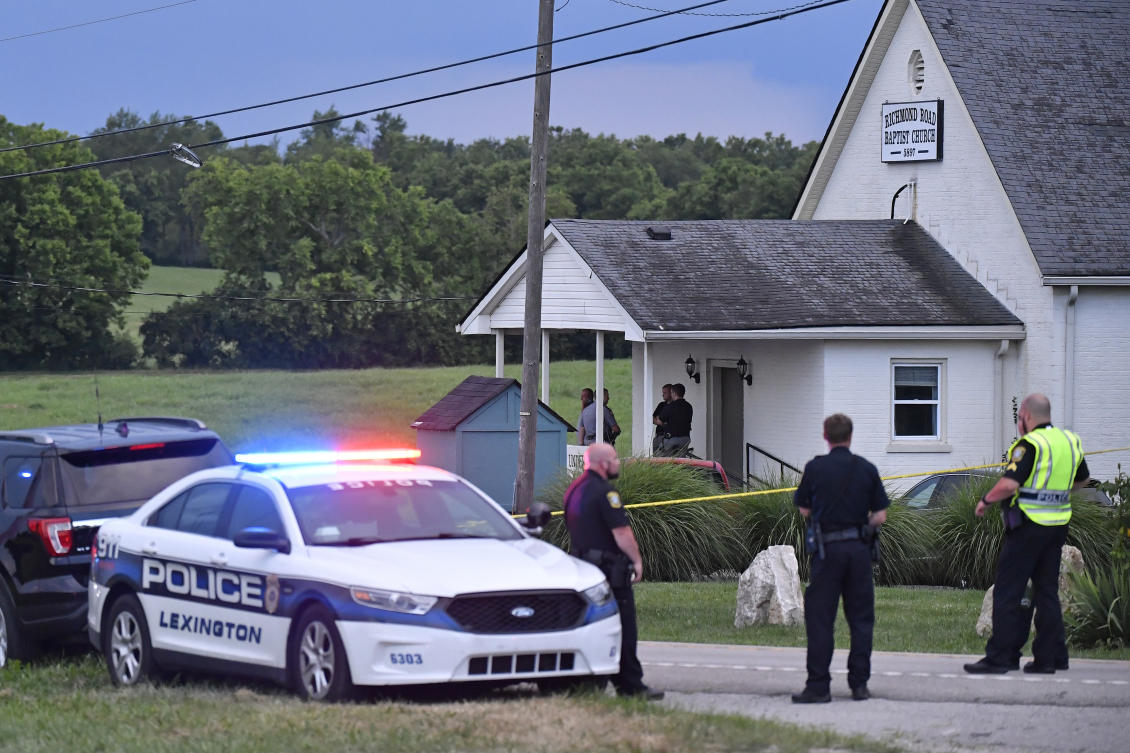 Police stand at the front of the Richmond Road Baptist Church as other officers maintain a perimeter following a shooting at the church in Lexington, Kentucky on July 13, 2025. (AP)