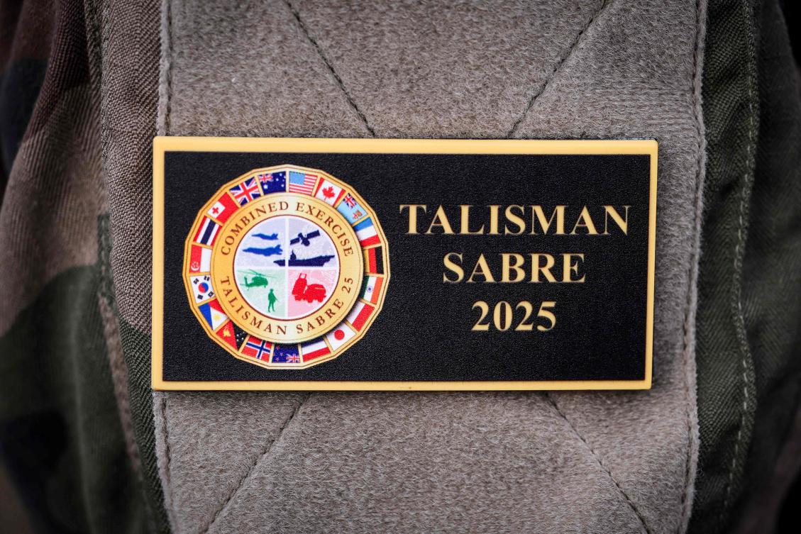 A member of the French defense forces wears a badge displaying the emblem of the annual Talisman Sabre exercise while aboard the French patrol vessel Auguste Benebig, in Sydney on July 13, 2025. (AFP)