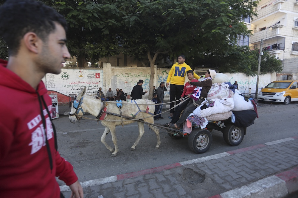 A 30-country conference in Bogota aims to end Israel’s occupation of Palestine. Palestinians ride on a donkey cart in Rafah. (AP file photo)