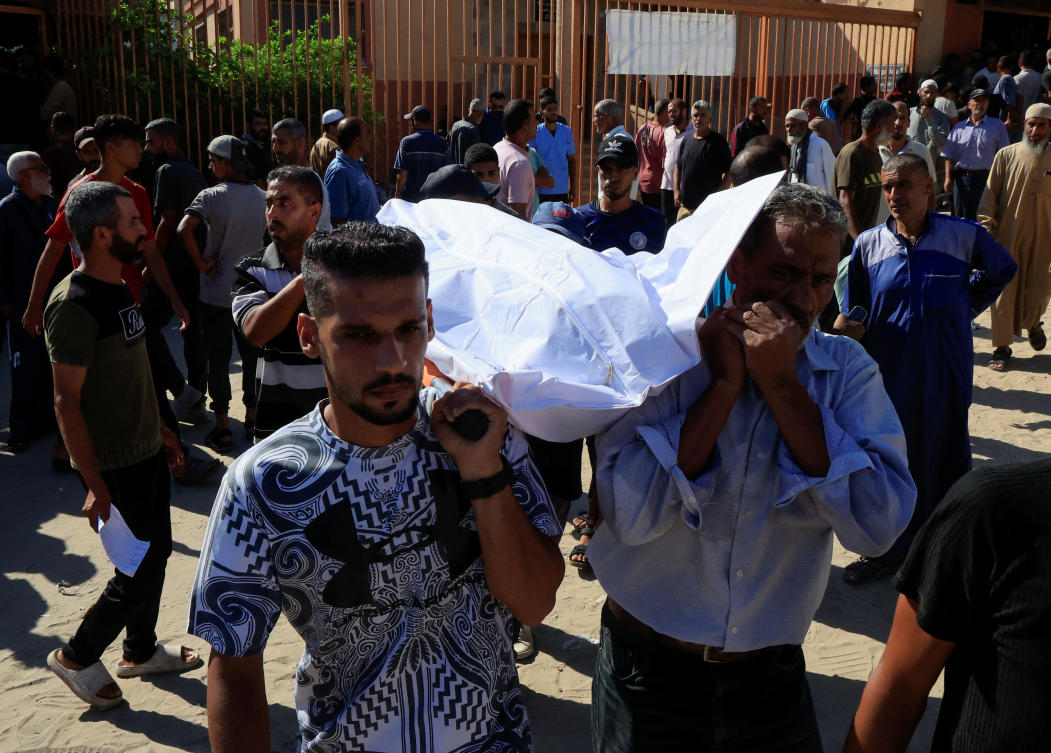 People carry a body as they mourn Palestinians who were killed in an incident on Wednesday while seeking aid in Khan Younis, at Nasser hospital in Khan Younis in the southern Gaza Strip July 16, 2025. (Reuters)