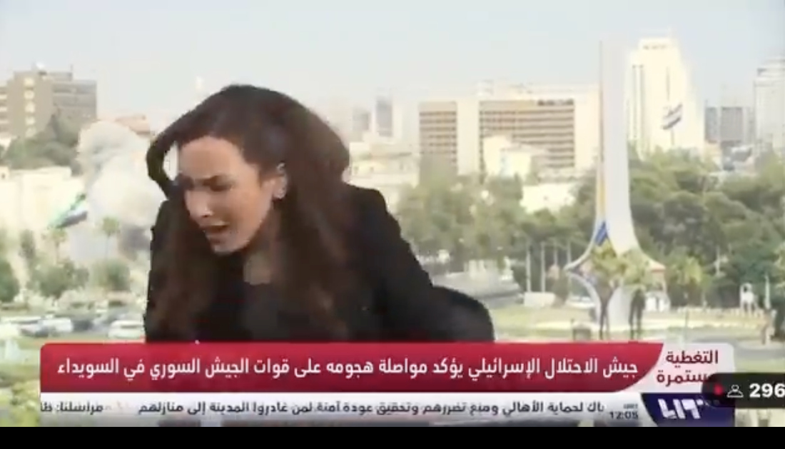 A Syrian presenter reacts in shock as an Israeli missile strikes a building in Damascus, interrupting her live broadcast. (X: @Israel_katz)