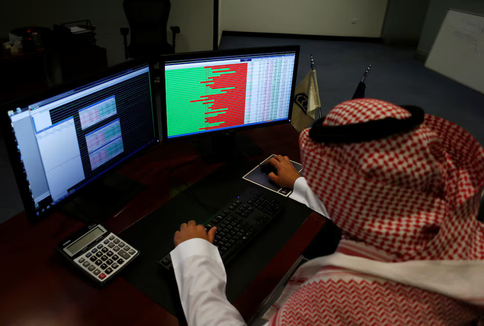 A Saudi trader observes the stock market on monitors at the Falcom stock exchange agency in Riyadh, Saudi Arabia. File/Reuters