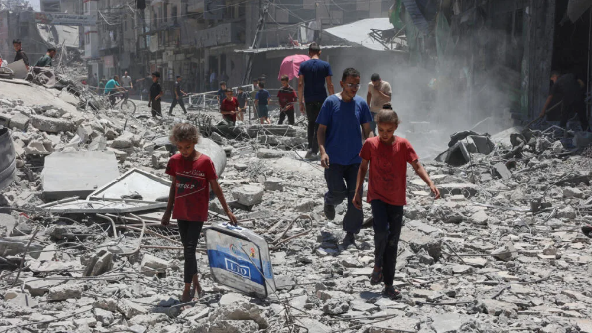 Palestinians search for items to salvage in the rubble of buildings destroyed a day earlier in Israeli strikes on Al-Daraj neighborhood in Gaza City on Wednesday. (AFP)