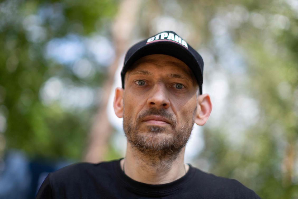 Belarusian opposition activist Sergei Tikhanovsky looks into the camera after an AFP interview, in a forest near Grodek, Poland, close to the Belarusian border, where he attends a festival organized by the Belarusian opposition on July 12, 2025. (AFP)