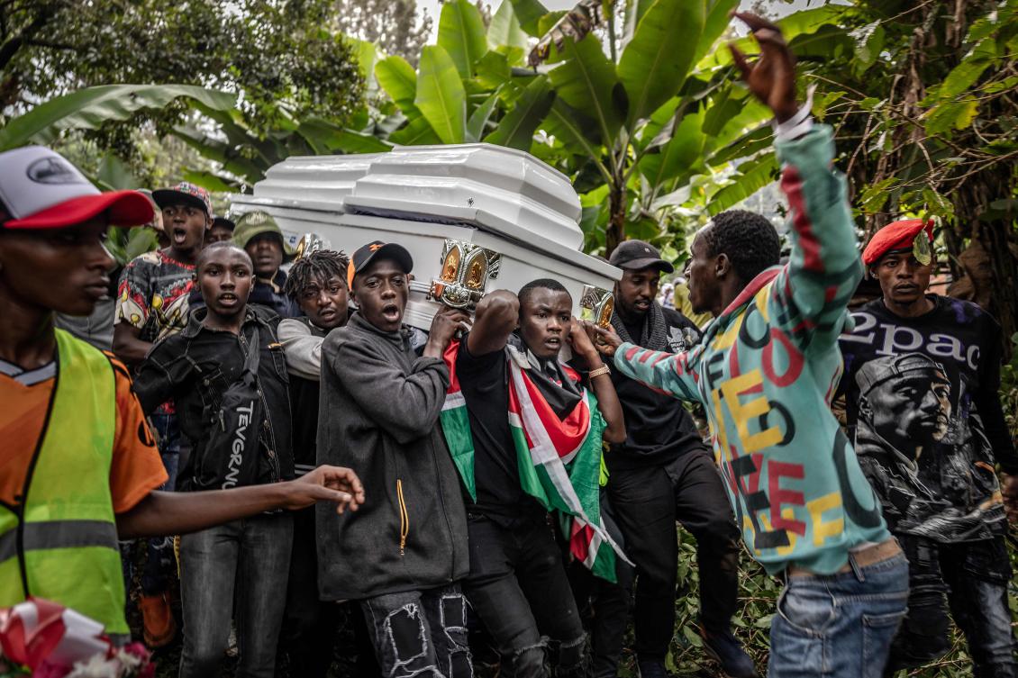 Young men carry the coffin of Boniface Kariuki, a street hawker who died from gunshot wounds days after being shot by Kenyan police during nationwide protests against police violence and government policies, during his funeral in a village near Kangema on July 11, 2025. (AFP)