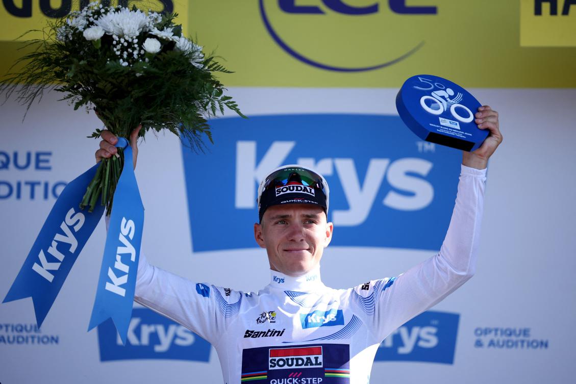 Soudal Quick-Step team’s Belgian rider Remco Evenepoel celebrates on the podium with the best young rider’s white jersey after the 13th stage of the 112th edition of the Tour de France cycling race, in the Pyrenees mountains of southwestern France, on July 18, 2025. (AFP)