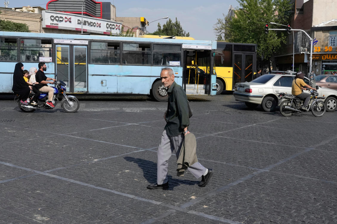 A man crosses an intersection on a hot summer day in downtown Tehran, Iran, Monday, July 21, 2025. (AP)