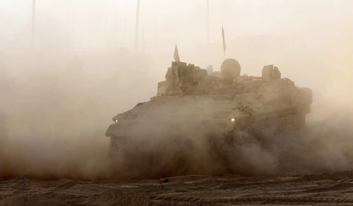 An Israeli armoured personnel carrier rolls at a position near the border with the Gaza Strip on July 21, 2025. (AFP)