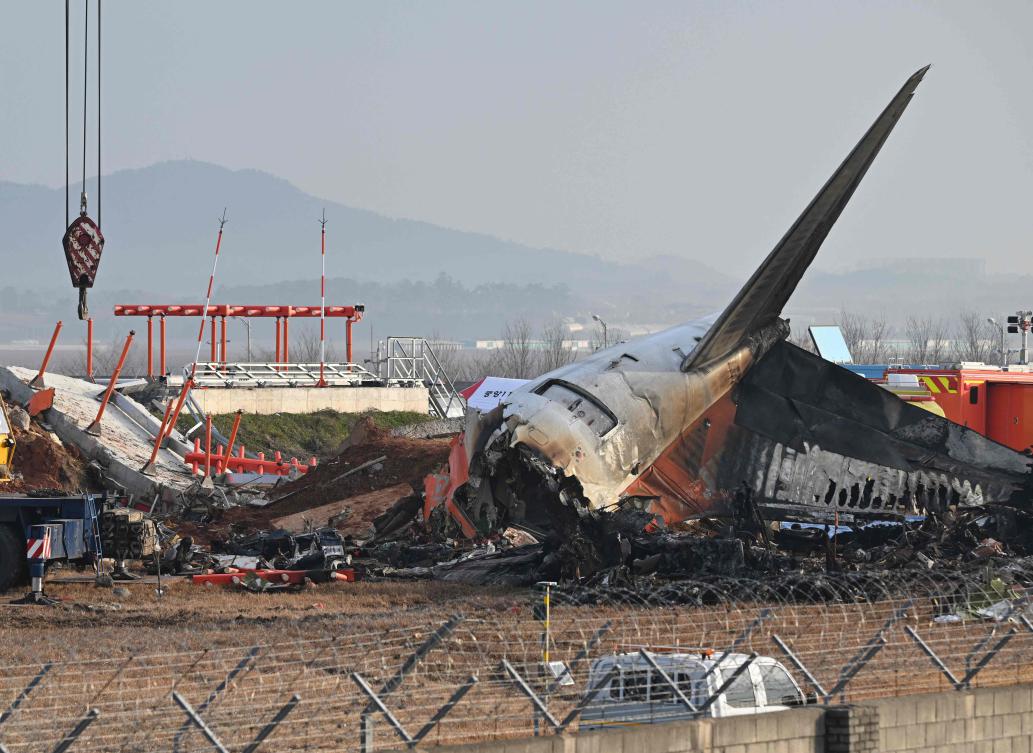 Above, the scene where a Jeju Air Boeing 737-800 series aircraft crashed and burst into flames is seen at Muan International Airport in Muan on Dec. 30, 2024. (AFP file photo)