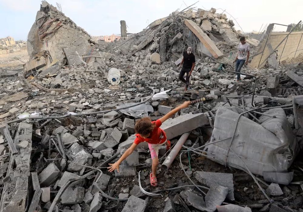 A Palestinian girl makes her way through rubble after an Israeli strike on Bureij refugee camp, central Gaza Strip, July 10, 2025. (AFP)