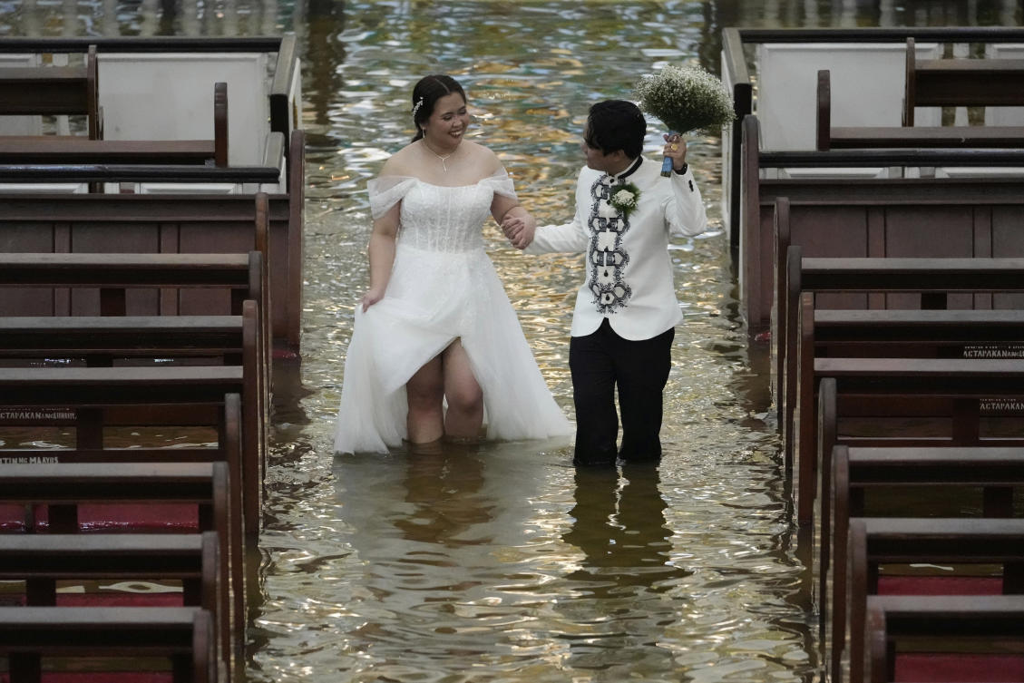 Photos show a Filipino couple walking down a flooded aisle on their wedding day