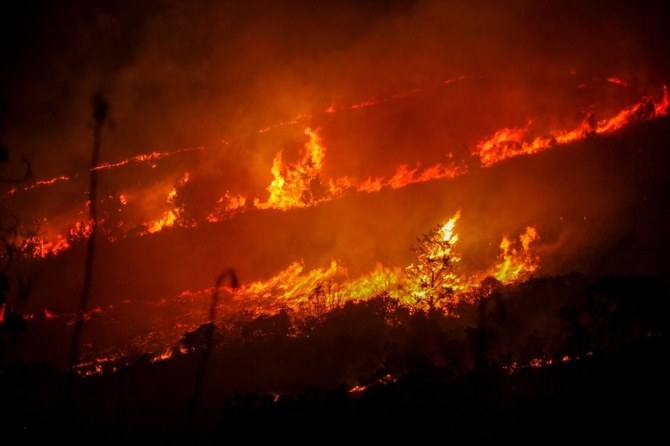 Firefighters in Cyprus were battling on Wednesday to contain a huge wildfire forcing the evacuation of at least four villages on the first day of a heatwave which sent temperatures soaring. (AFP/File)