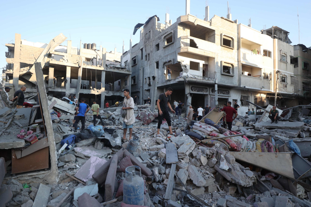 Palestinians inspect the damage after an Israeli strike on the Bureij refugee camp in the central Gaza Strip on July 23, 2025. (AFP)