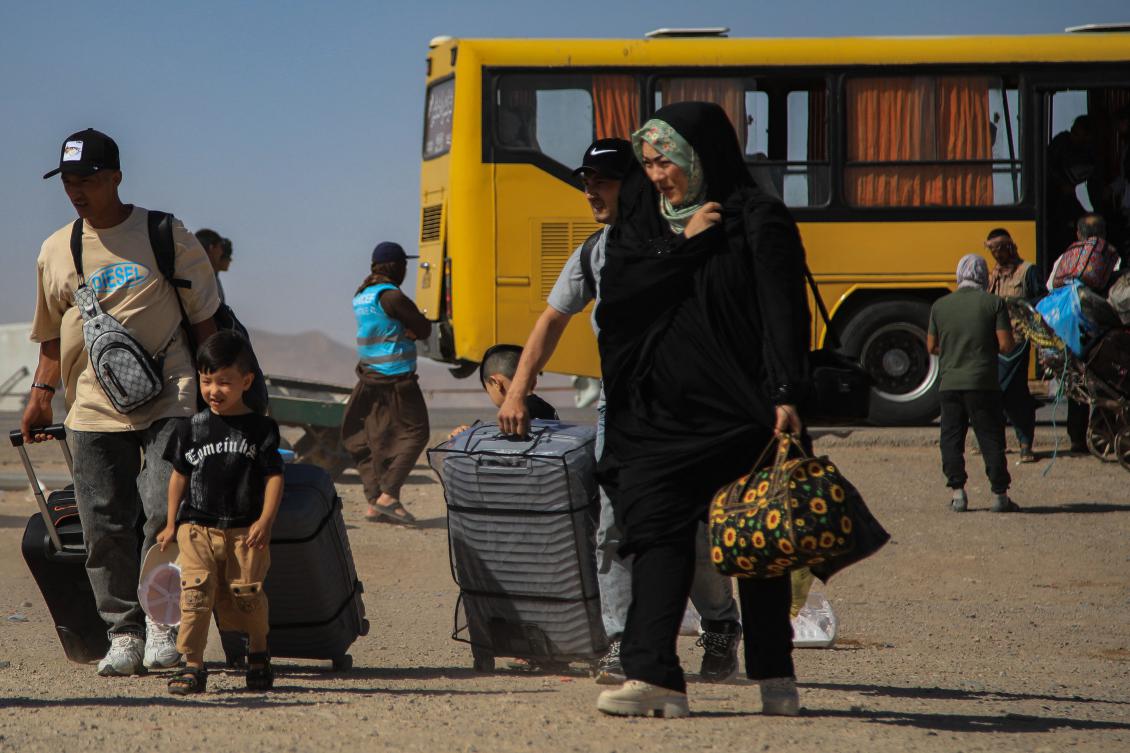 An Iranian bus drops off Afghan refugees at Zero Point on the Islam Qala border in Herat Province on July 24, 2025. (AFP)
