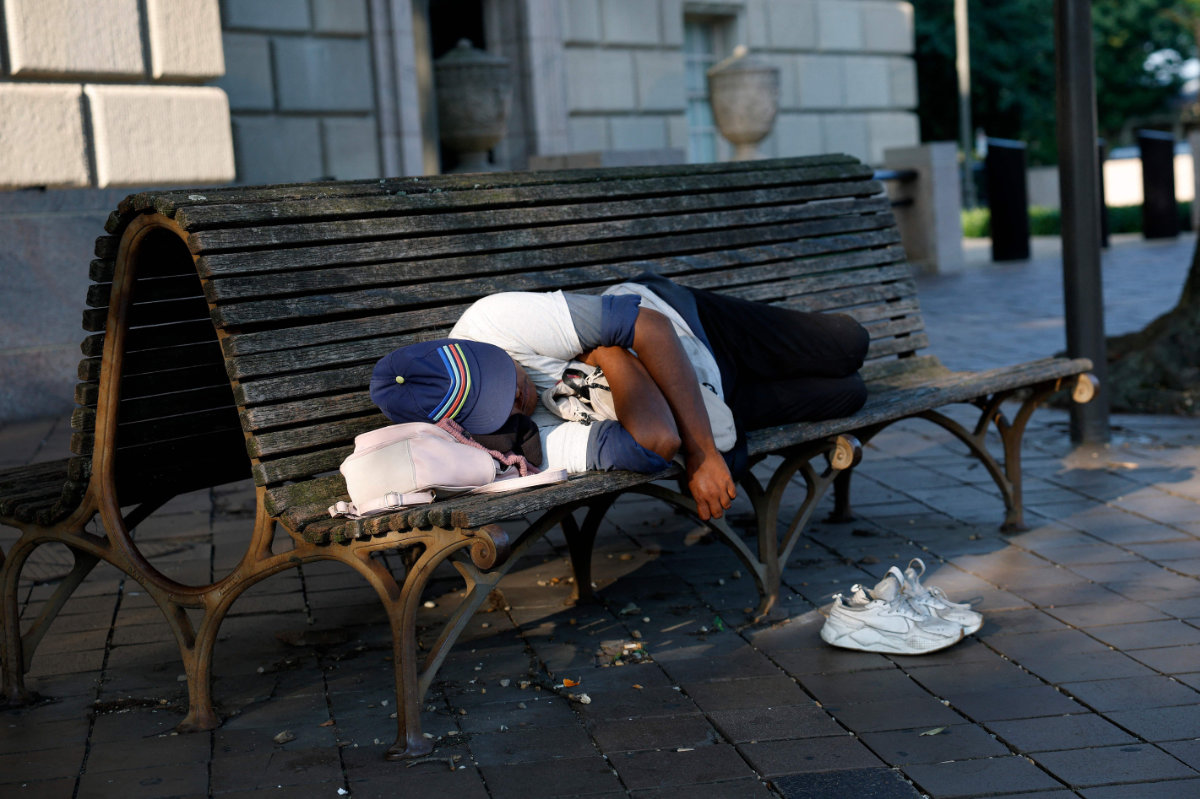 A person sleeps on a bench on July 25, 2025 in Washington, DC. (Getty Images via AFP)