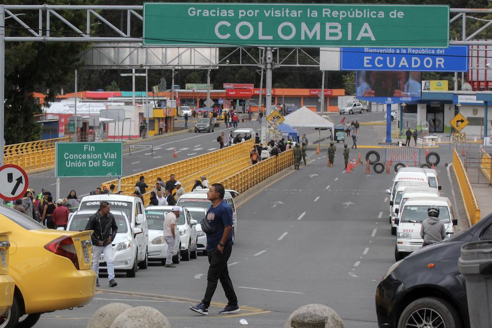 Above, vehicles wait to cross the Rumichaca International Bridge at Colombia and Ecuador’s shared border on Feb. 8, 2025. (AFP)