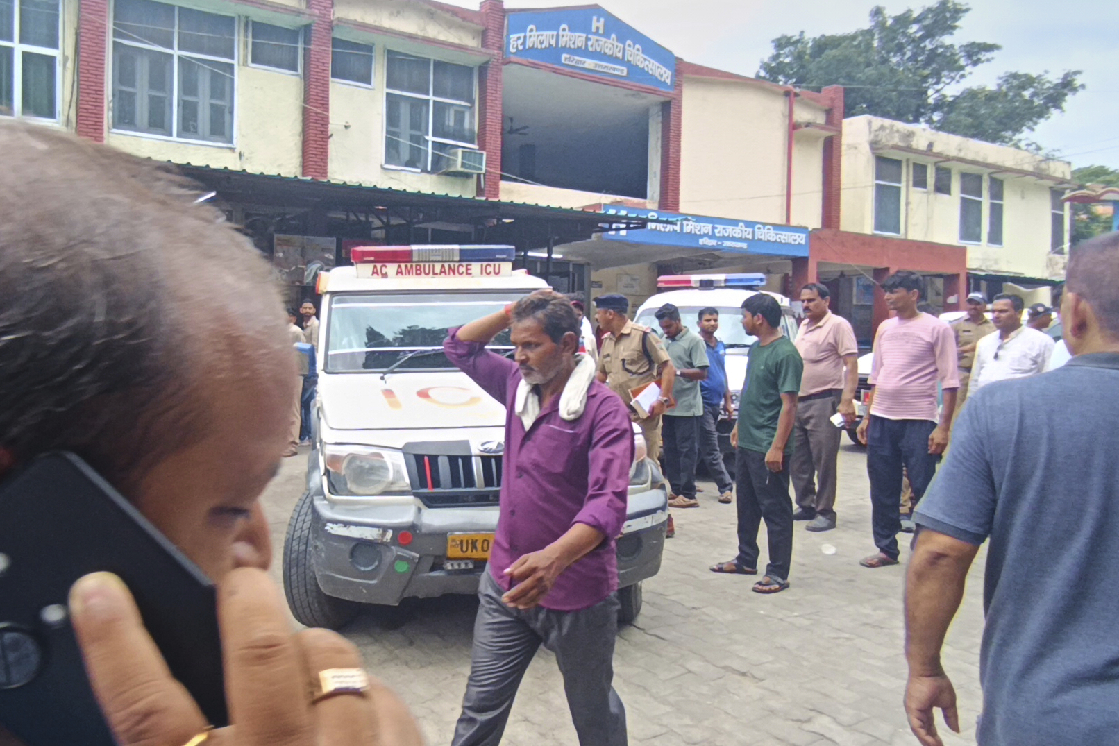 Relatives stand outside a hospital as the injured from the temple stampede were brought, in Haridwar, India, on July 27, 2025. (AP)