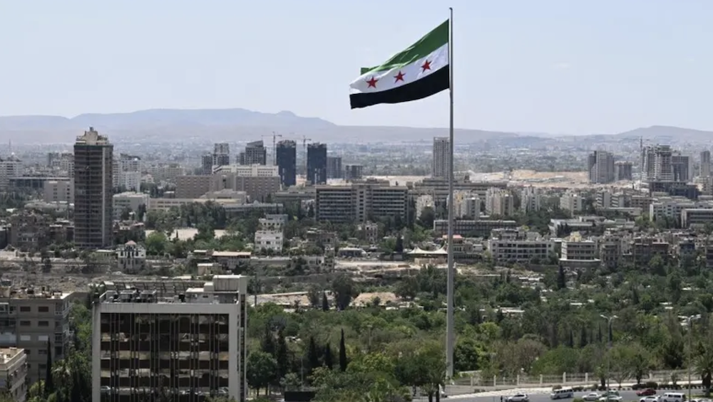 A large Syrian flag flutters above Tishreen Park in Damascus on June 4, 2025. (AFP)