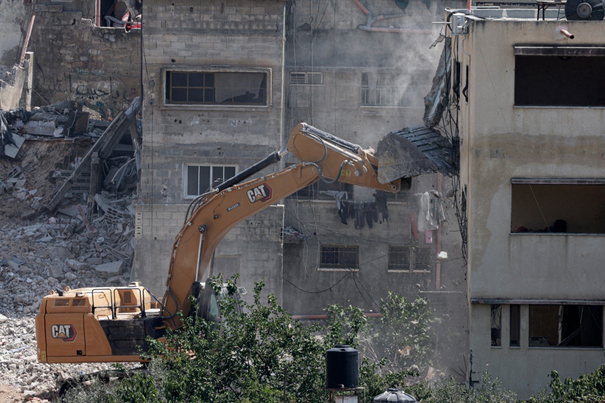 An Israeli military bulldozer demolishes a home at the Nur Shams Palestinian refugee camp, east of Tulkarem, June 23, 2025. (AFP)