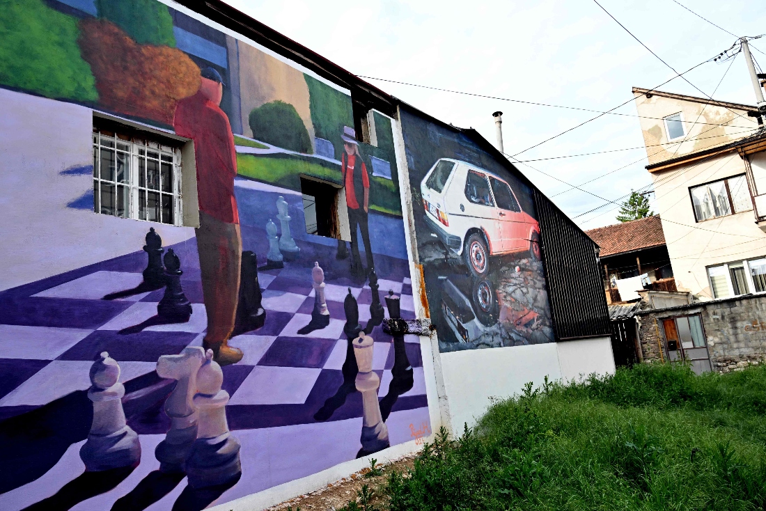 facades of old buildings renovated with murals by Bosnian street artist Benjamin Cengic and his creative team in Sarajevo. (AFP)