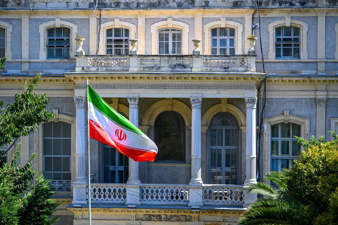 An Iranian flag flutters in front of the Iranian Consulate, where Iranian diplomats meet counterparts from Germany, Britain and France for renewed nuclear talks, amid warnings that the three European powers could trigger "snapback" sanctions outlined under the 2015 deal, in Istanbul, Turkey, on July 25, 2025. (AFP)
