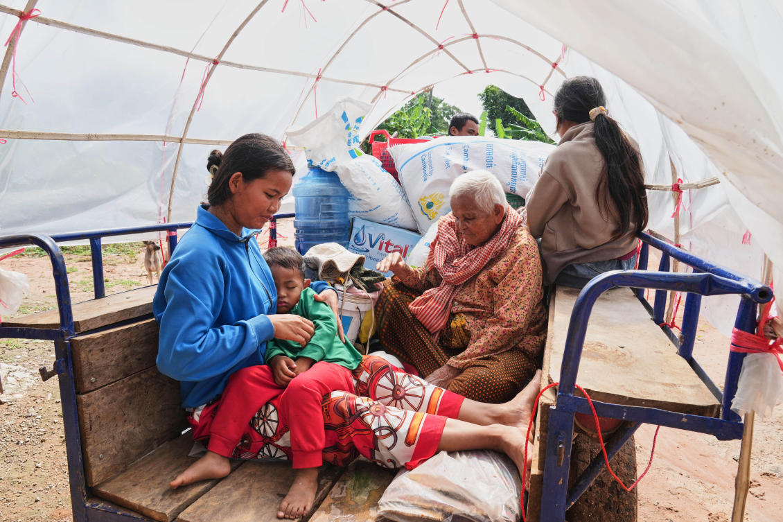 A Cambodian family sits on a tractor cart of as they return home from a temporary shelter in Prasat Roboeuk village of Oddar Meanchey province on July 29, 2025. (AP)