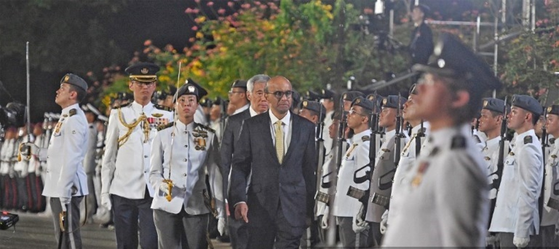 Mr Tharman Shanmugaratnam, together with Prime Minister Lee Hsien Loong, taking part in the inspection of the guards ceremony at the Istana ahead of his inauguration in Singapore. (AFP)