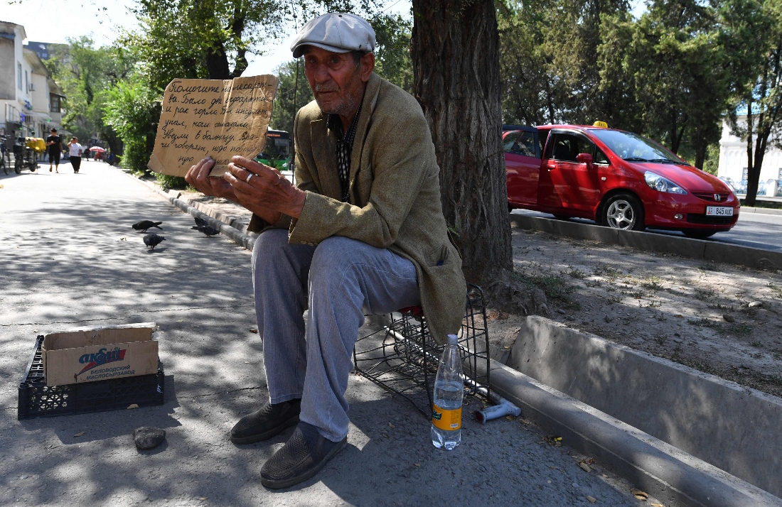A man asks for donation for medicines in Bishkek, Kyrgyzstan. (AFP)
