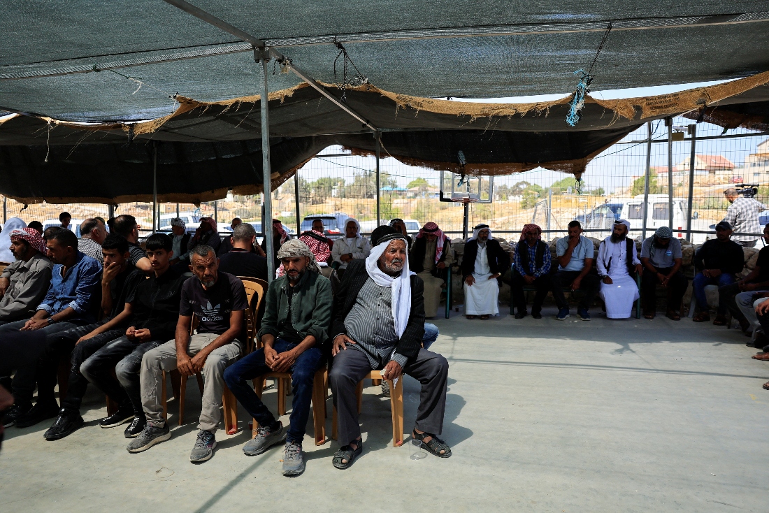 Men gather in the aftermath of a clash with an Israeli settler at the village of Umm al Khair in the Israeli occupied West Bank. (Reuters)