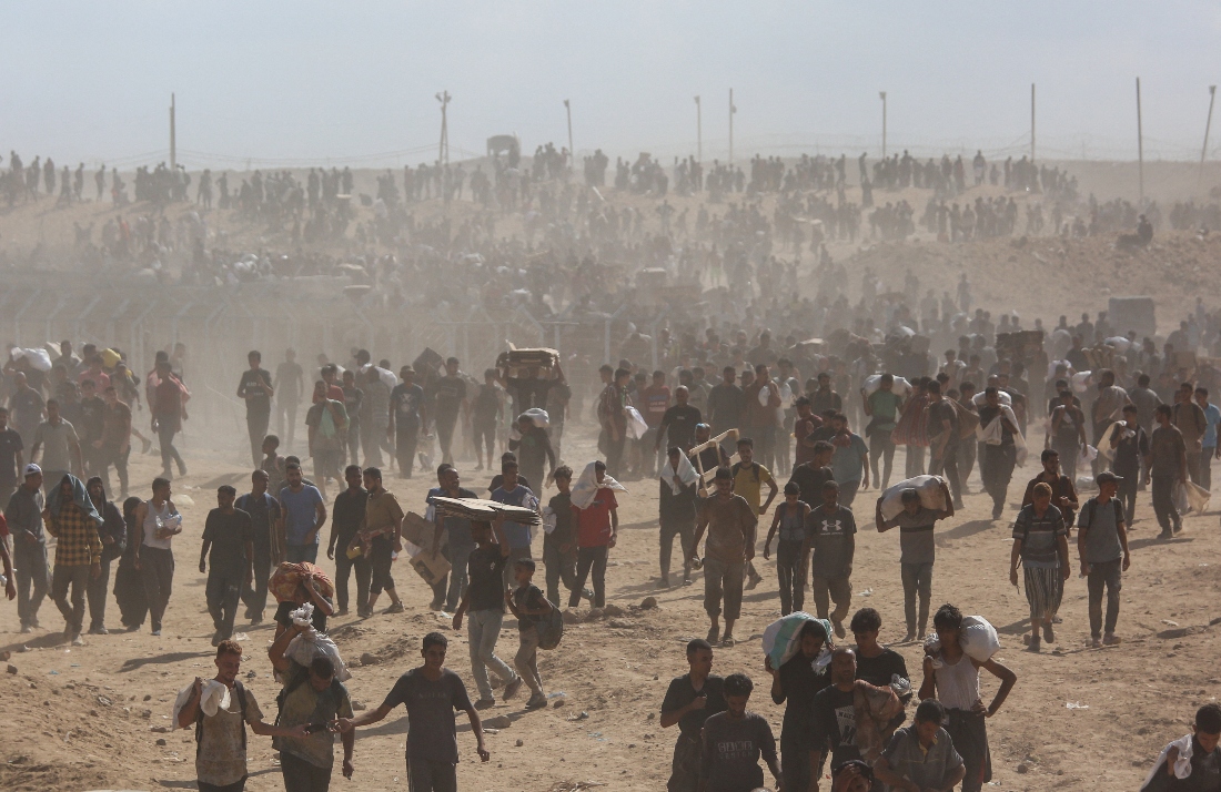 Palestinians carry aid supplies in the central Gaza Strip. (Reuters)