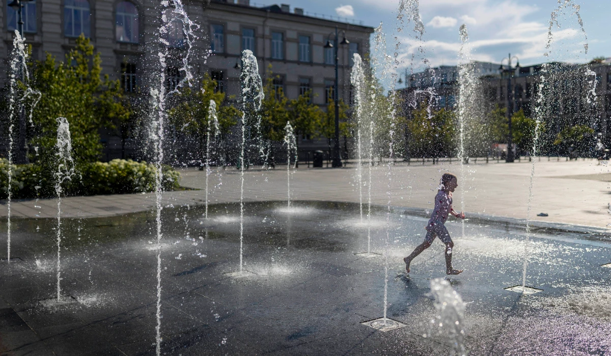 A girl cools off on a hot day in a public fountain in Vilnius, Lithuania, Sunday, July 13, 2025. (AP)