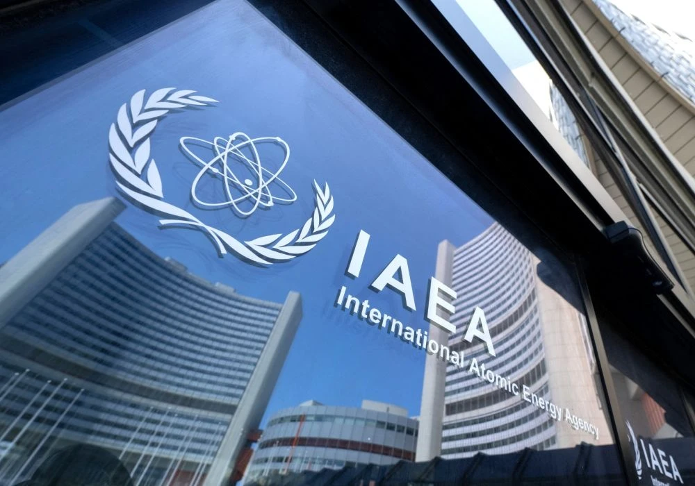 Buildings of the International Atomic Energy Agency (IAEA) headquarters reflect in doors with the agency’s logo during the IAEA’s Board of Governors meeting in Vienna, Austria, June 13, 2025. (AFP)