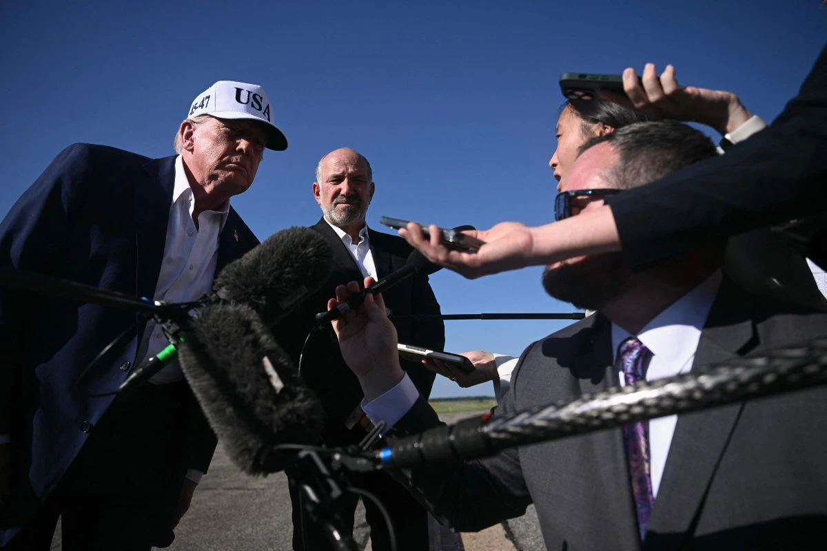 US President Donald Trump and Secretary of Commerce Howard Lutnick speak to reporters before boarding Air Force One at Morristown Municipal Airport in Morristown, New Jersey, on July 6, 2025, en route to Washington after spending the weekend at his residence in Bedminster, New Jersey. (AFP)