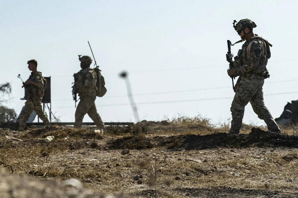 US soldiers inspect the site of reported Turkish shelling days earlier on an oil extraction facility on the outskirts of Rumaylan, in Syria's Kurdish-controlled northeastern Hasakeh province on October 28, 2024. (AFP)