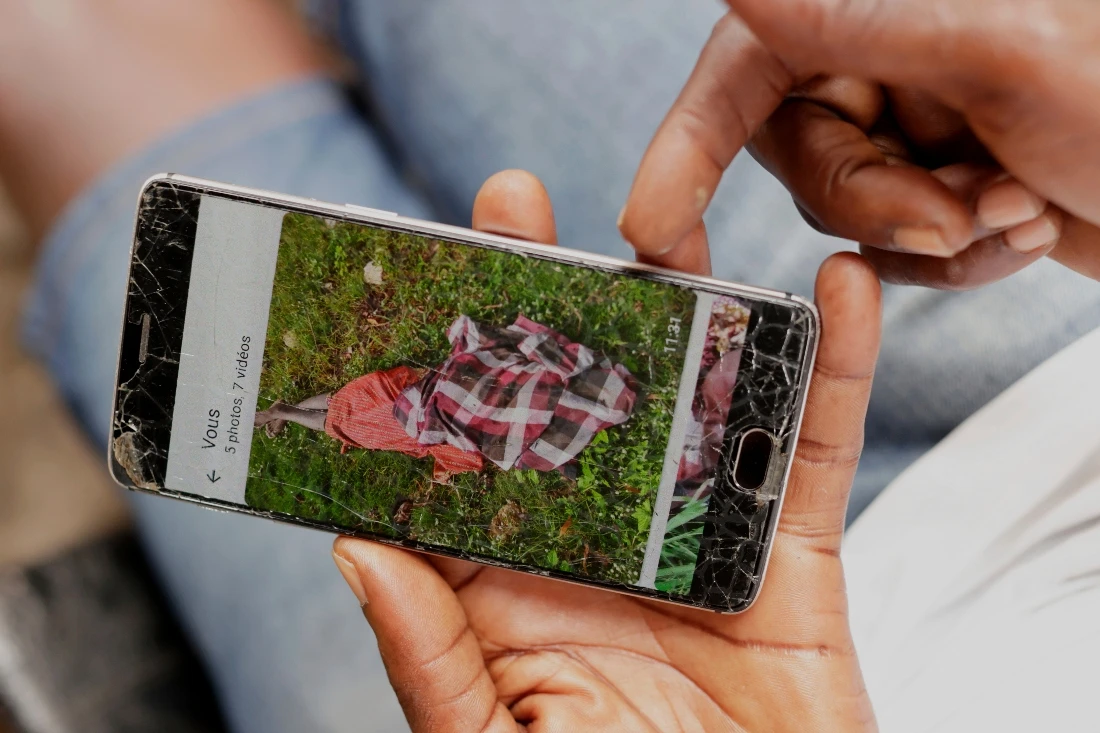 Koutoglo Kossi Mawuli, the uncle of late 15-year-old Jacques Koami Koutoglo, shows a photograph of his body on a mobile phone after it was recovered from a lagoon in Lome, Togo. (AP)