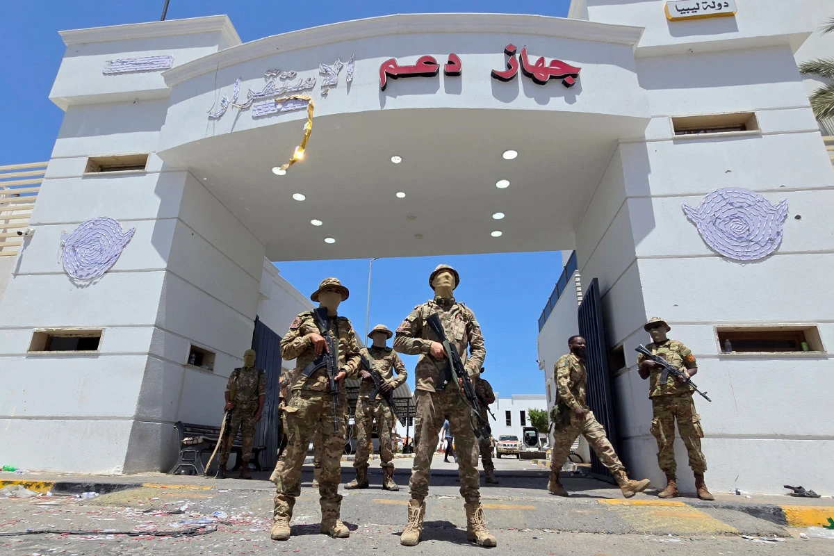 Libyan security forces stand guard outside a police building that they recaptured following overnight clashes in the southern district of Abu Salim in the capital Tripoli on May 13, 2025. (AFP/File)