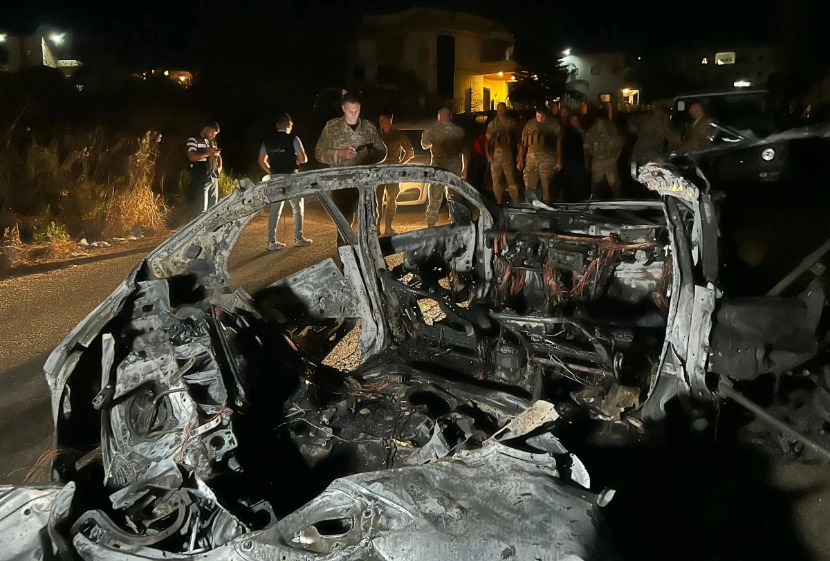 Lebanese army soldiers inspect the wreckage of a car which was targeted by an Israeli drone attack on a street in the southern Lebanese village of Babliyeh, July 8, 2025. (AFP)