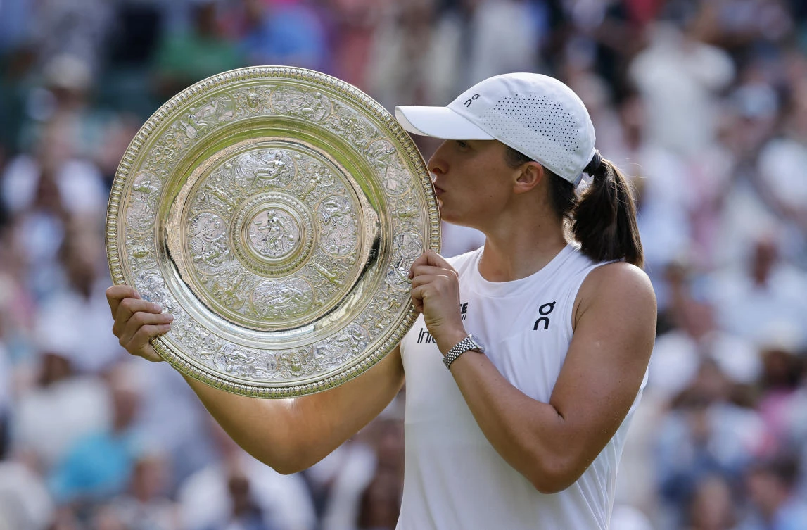 Poland’s Iga Swiatek celebrates with the trophy after winning the women’s singles final against Amanda Anisimova of the US. (Reuters)