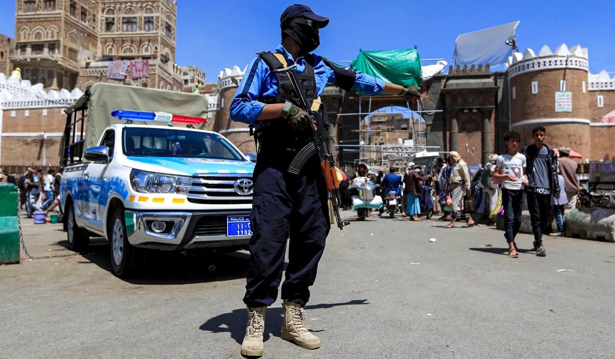A member of the traffic police forces loyal to Yemen's Houthi rebels controls traffic along a road in the Houthi-held capital Sanaa on March 24, 2022. (AFP)
