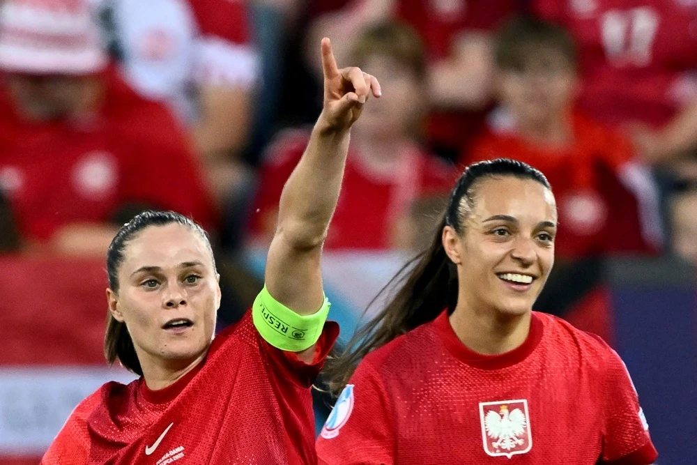 Poland's forward Ewa Pajor, left, and teammate Natalia Padilla Bidas celebrate after each scored back-to- back goals in Lucerne. (AFP)