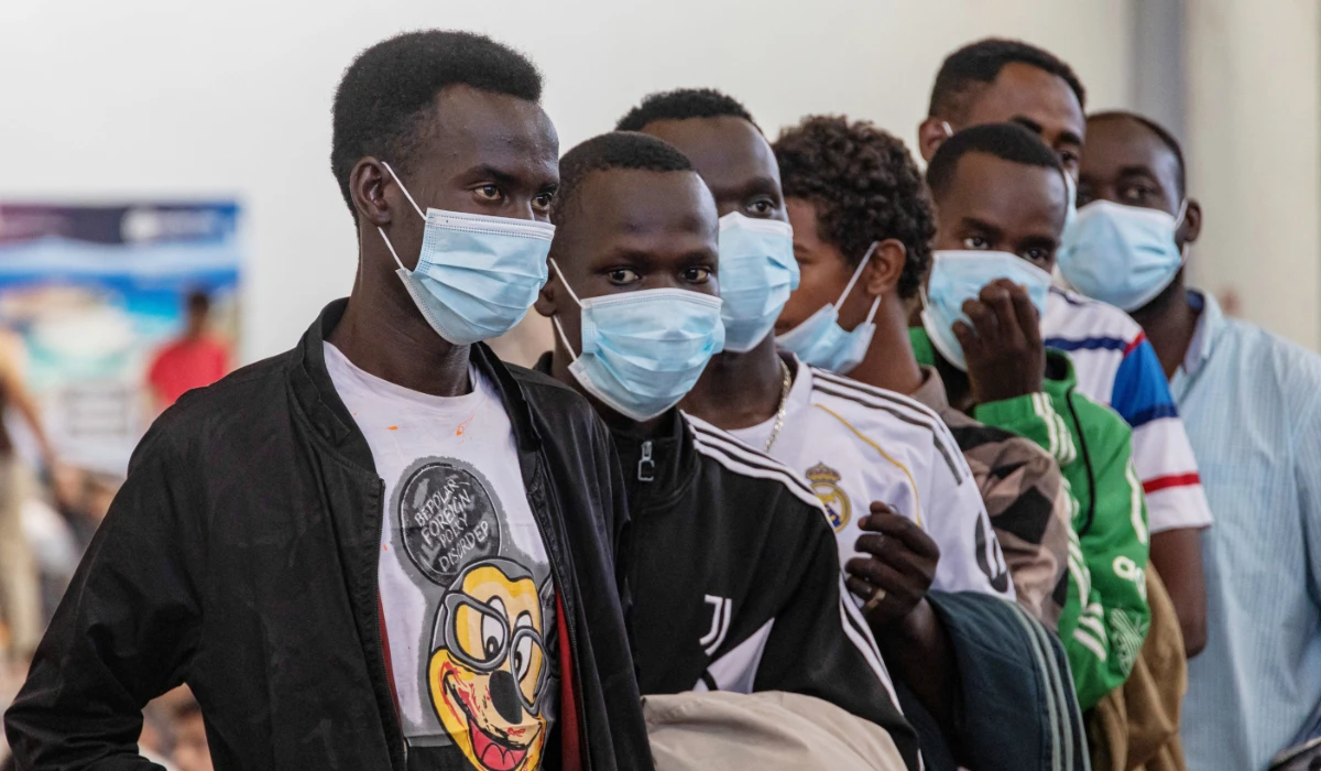 Newly-arrived migrants line up inside a municipal hall in the town of Agyia, on the island of Crete, Greece, July 13, 2025. (REUTERS)