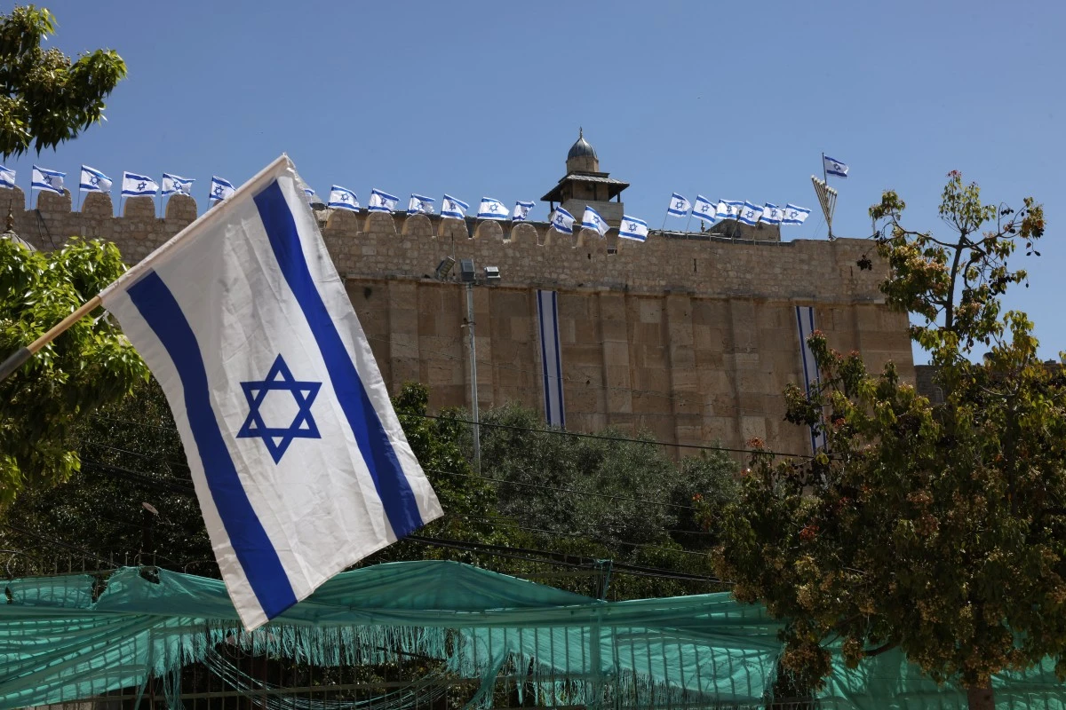 Ahead of Israel's Independence Day, Israeli flags decorate the Ibrahimi Mosque, known to Jews as the Cave of the Patriarchs, in Hebron city in the Israeli-occupied West Bank, April 29, 2025. (AFP)